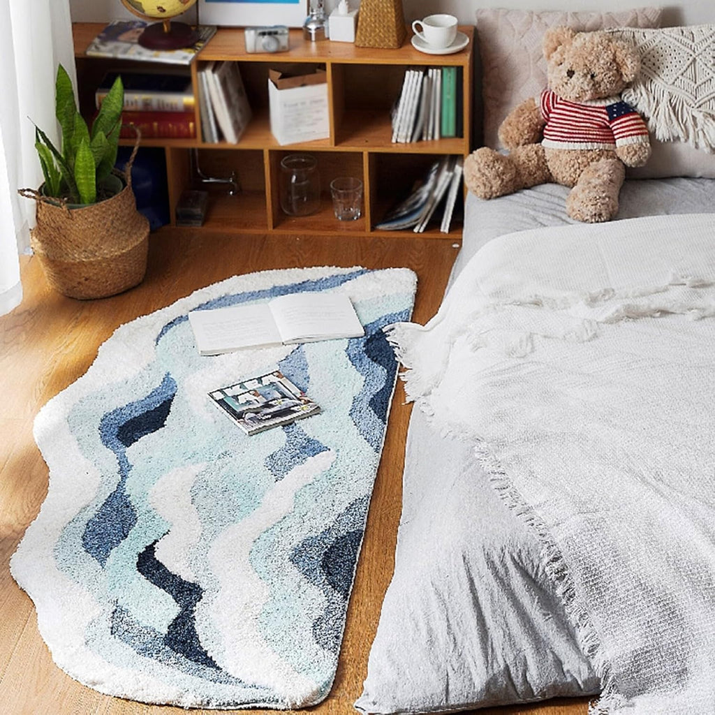 Fluffy wave-shaped bath mat in soft neutral tones, shown flat to display absorbent texture and non-slip bathroom rug design