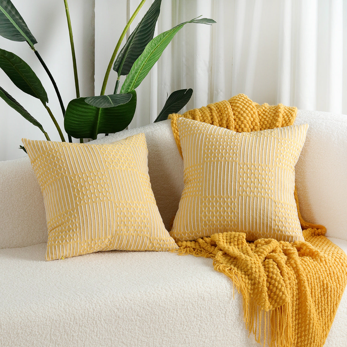 Close-up of a geometric jacquard cotton pillow cover showing textured woven pattern detail in neutral tones