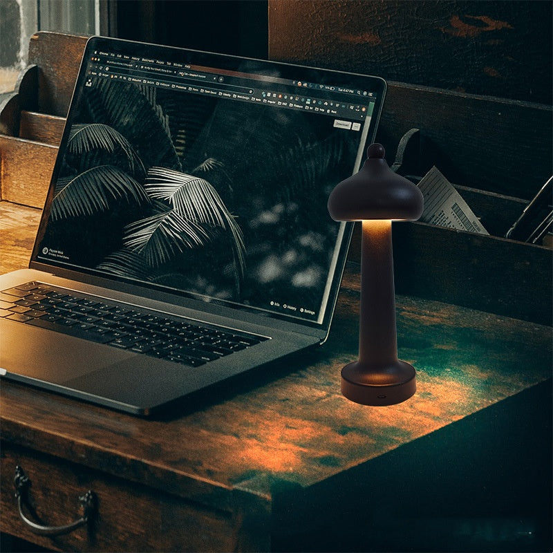 Modern minimalist LED USB table lamp emitting a soft warm glow, shown as a sleek decorative night light on a surface